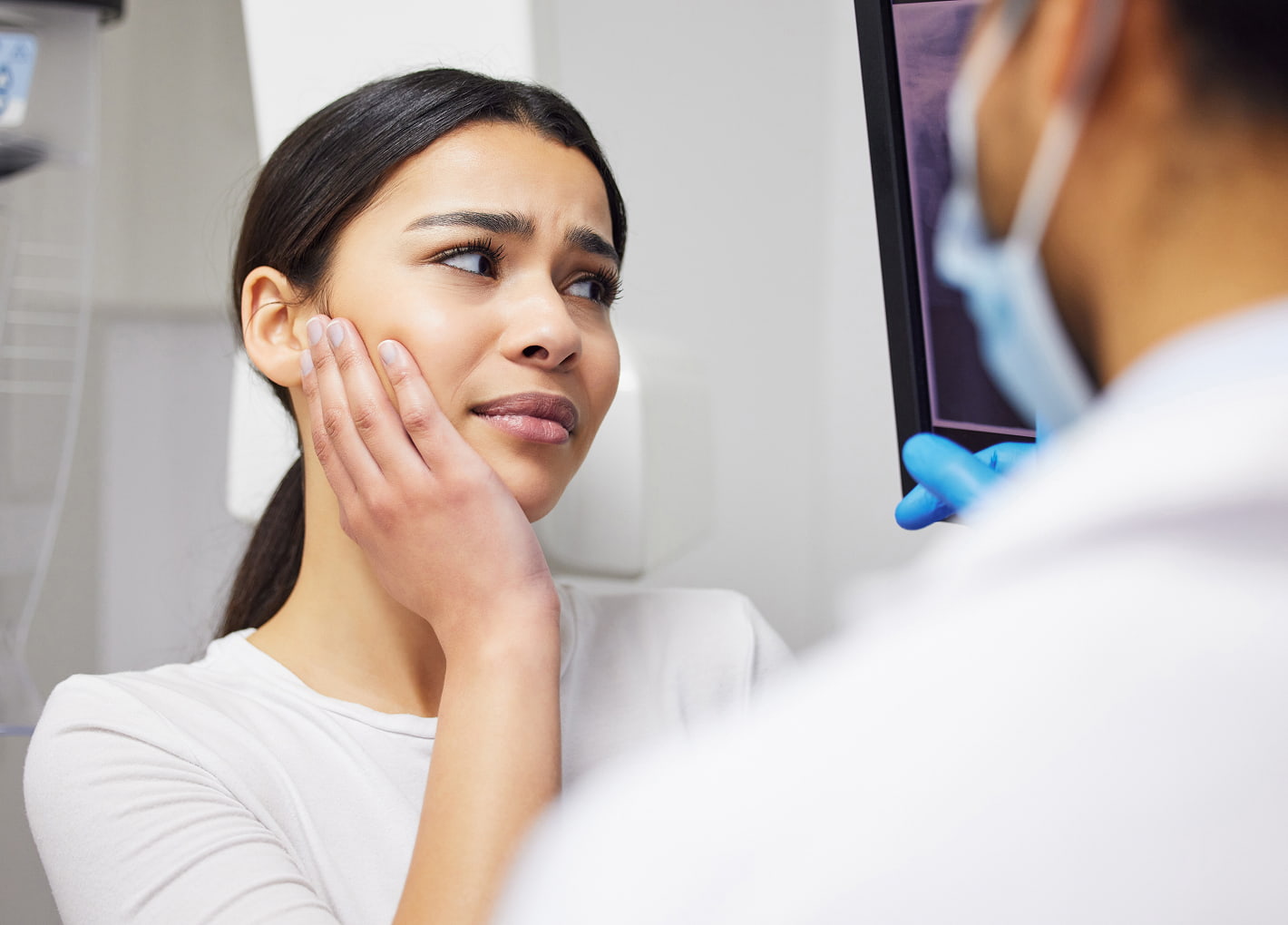 Dentist treating a patient during an emergency visit