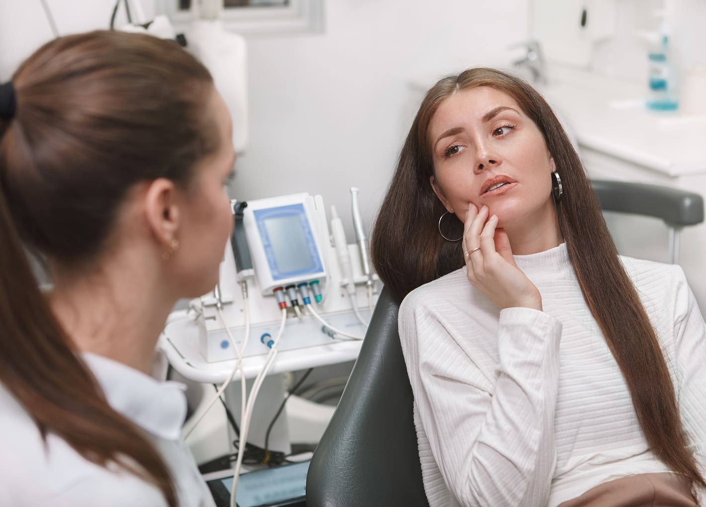 Patient in pain receiving emergency dental treatment