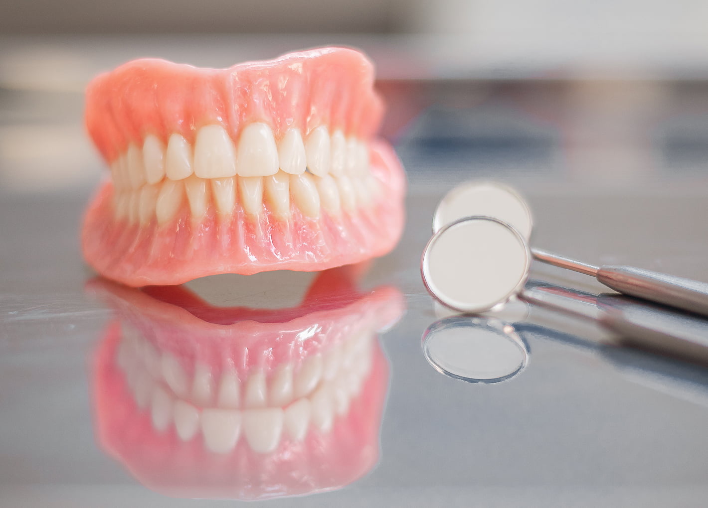 Patient smiling with partial dentures