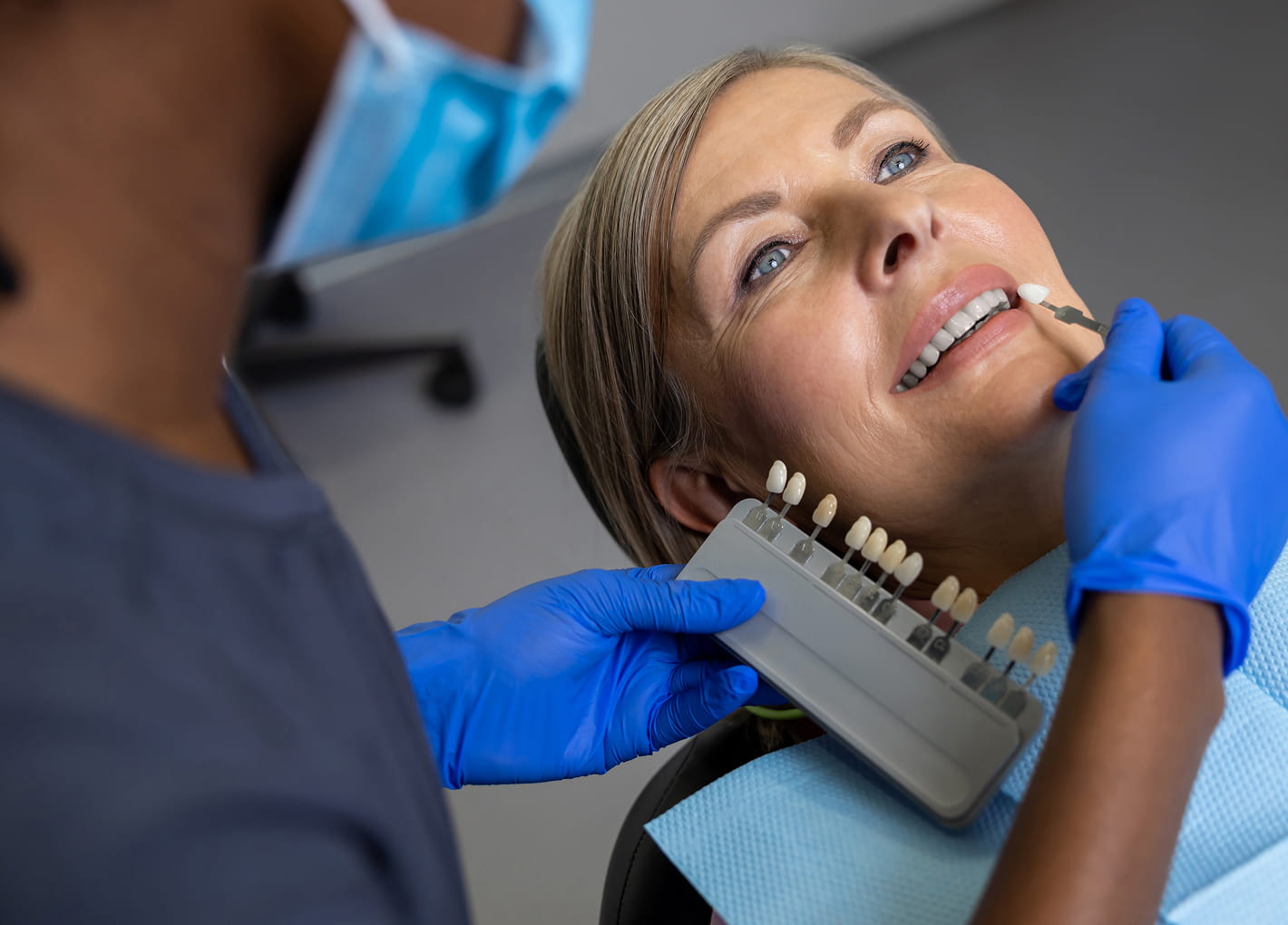 Patient smiling with newly placed dental veneers