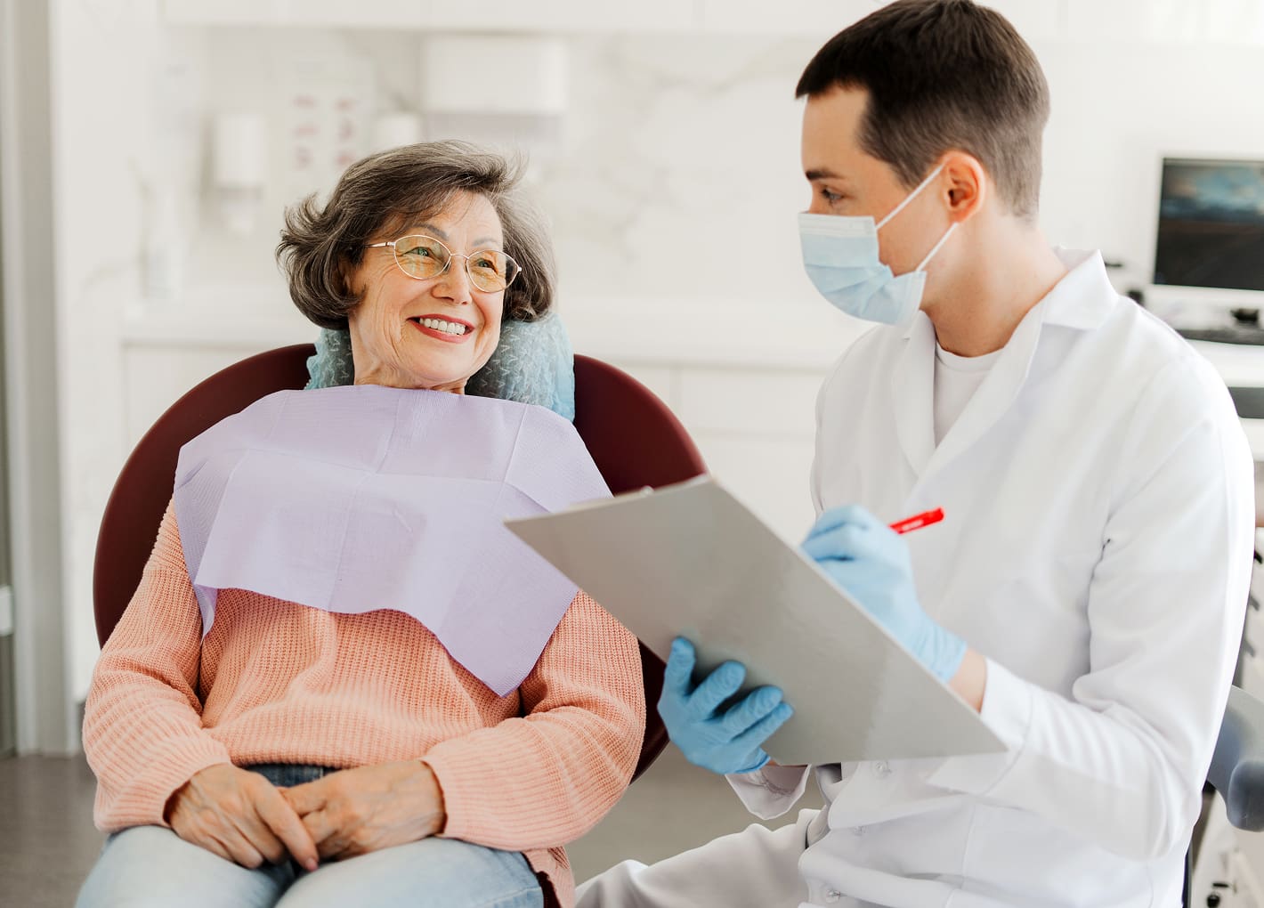 Dentist consulting with a patient using advanced imaging tool